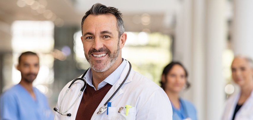 Headshot of a doctor in a hospital lobby.