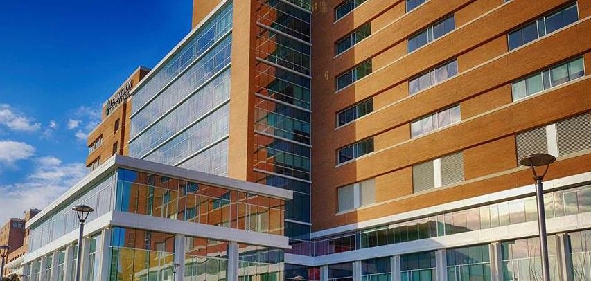 View of the glass-fronted entrance to Lexington Medical Center North Tower on a sunny day.