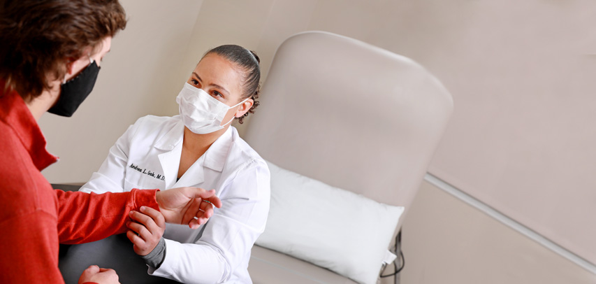 Dr. Andrea Gale evaluating a patient’s wrist.